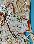 Close-up detail of a personalized marathon route map showing layered wood streets and red race course line, precision laser-cut design.