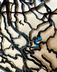 Close-up detail of San Juan Puerto Rico framed 3D city map, handcrafted laser-cut wood layers, raised street network and coastal design wall decor.
