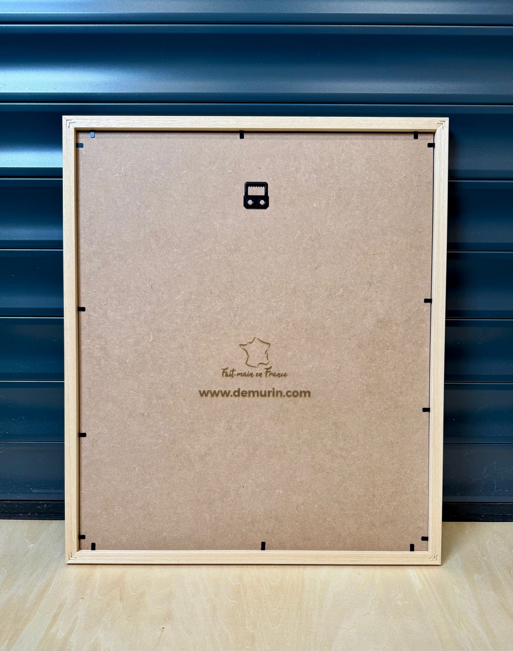 Close-up of the back panel of a Puerto Rico 3D city map wall art frame in natural wood, laser-engraved with “Fait main en France” and www.demurin.com, showcasing authentic French handcrafted quality.