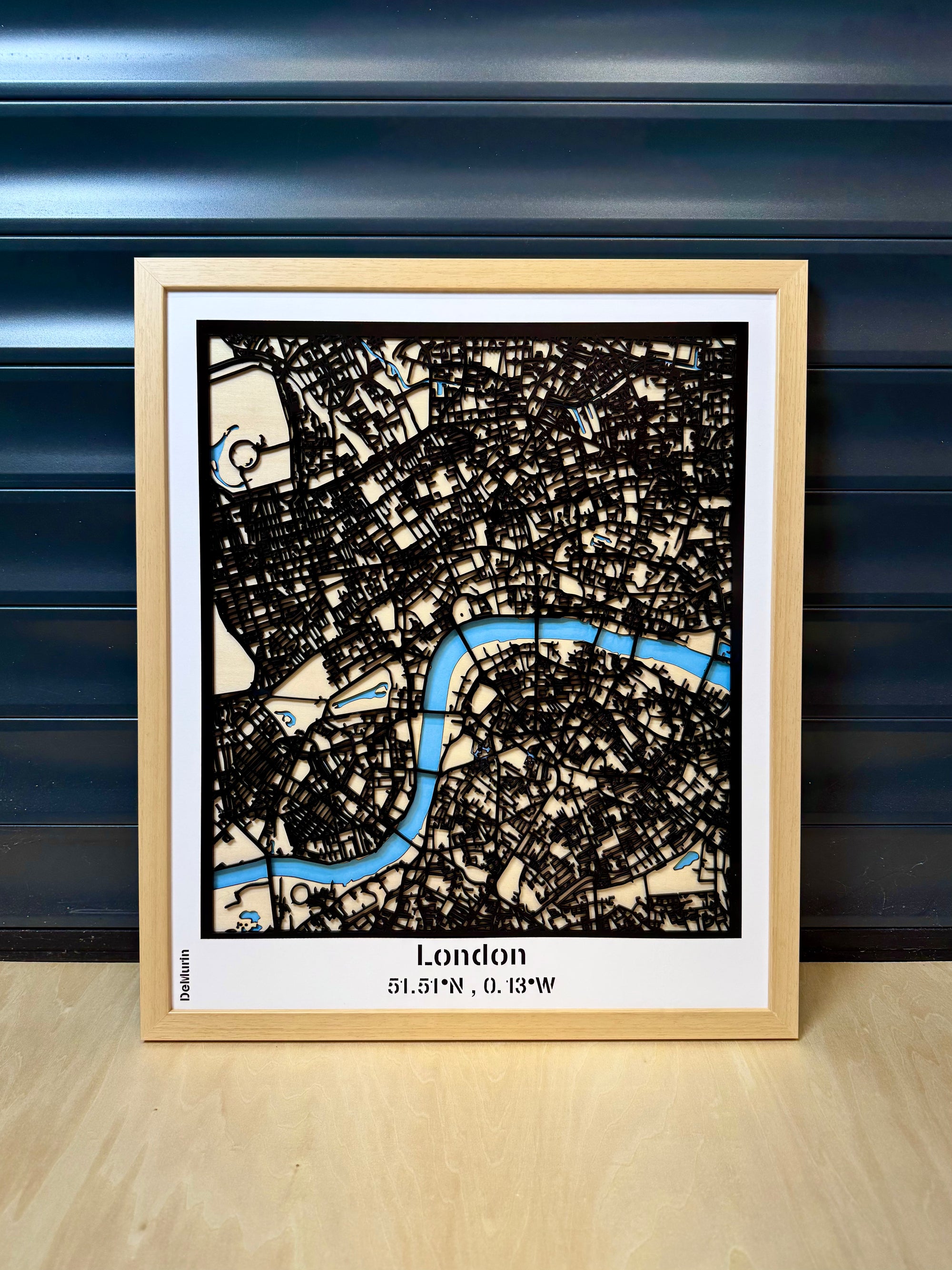 London city map wall art in natural wood frame – 3D laser-cut street map with the River Thames in blue, handcrafted in France, customizable home decor gift.