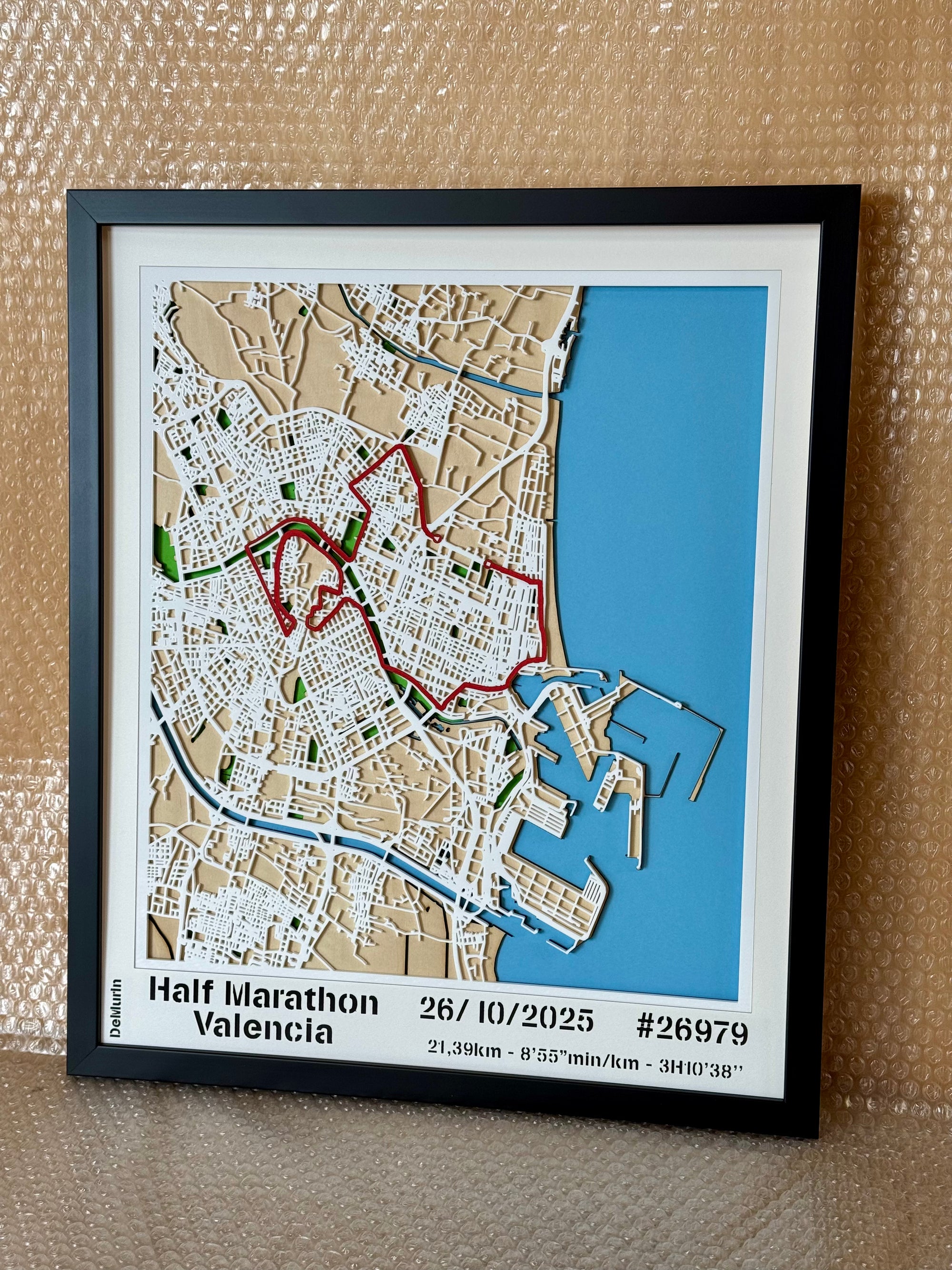 Personalized Half Marathon route map wall art with finish time and bib number, laser-cut layered wooden design, framed in black.