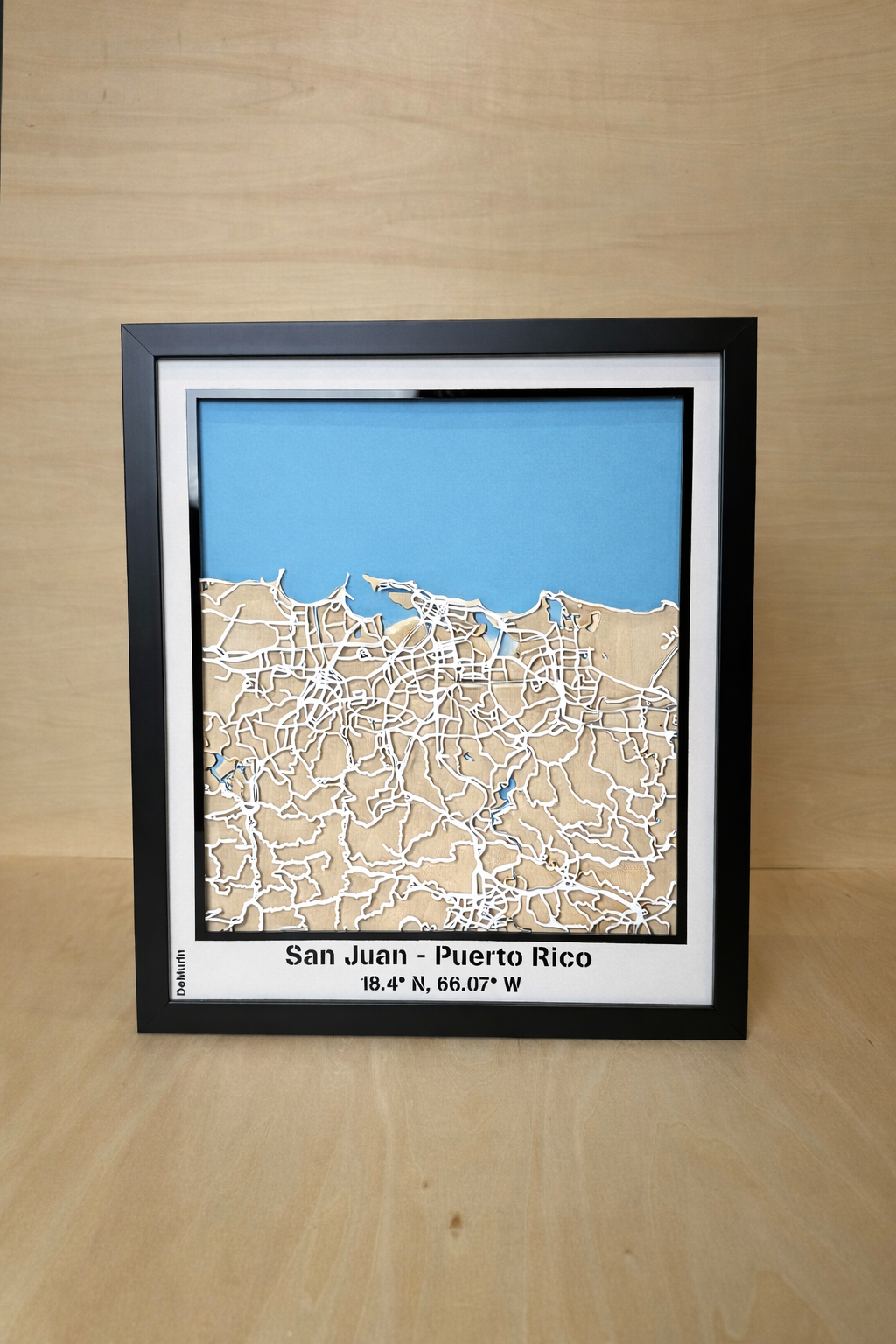 Full view of San Juan Puerto Rico framed 3D city map featuring white precision laser-cut street network, natural wood layers and blue sea detail, handcrafted wall art.