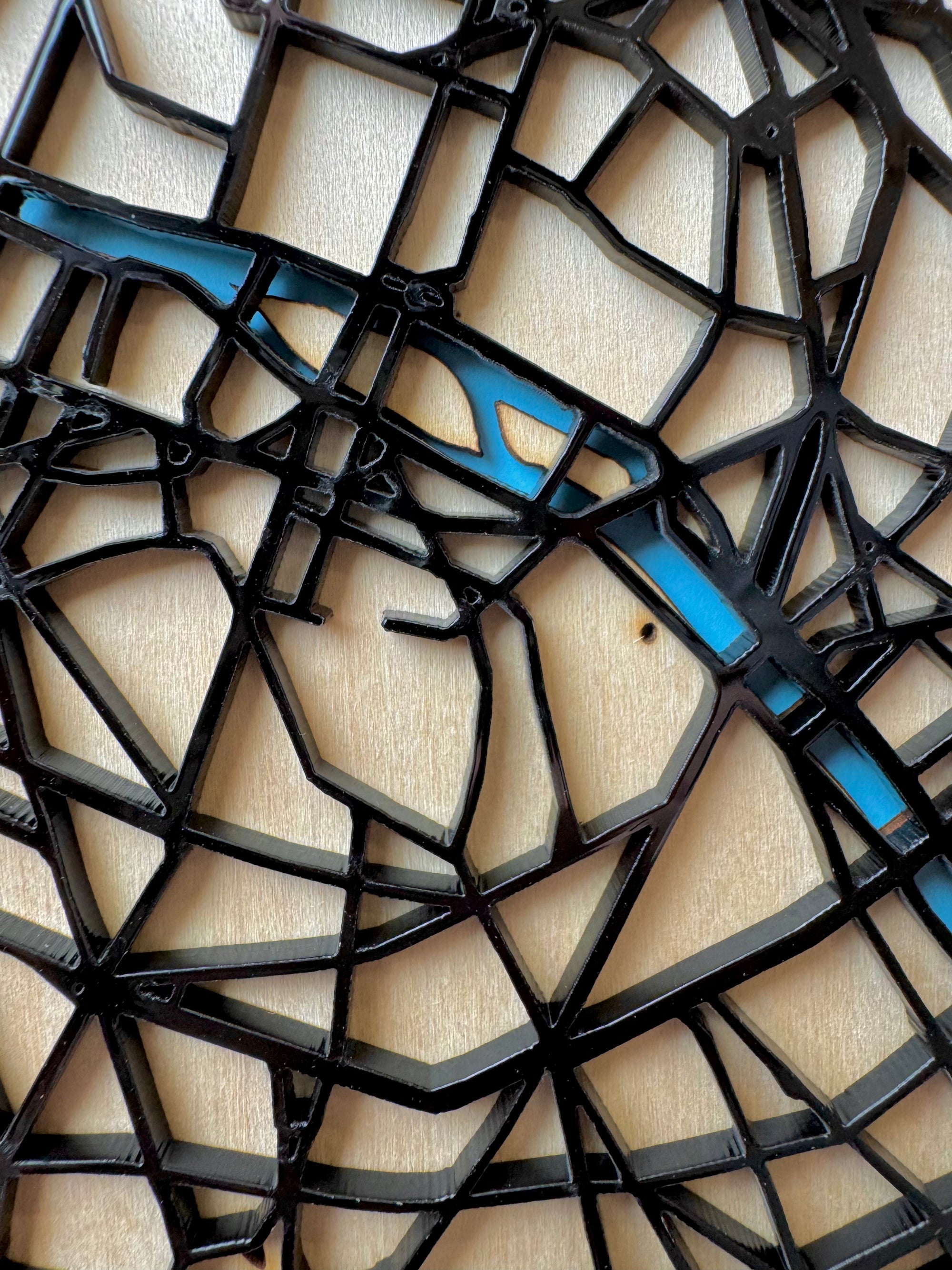 Personalized Paris city map wall art frame with coordinates – detailed laser-cut wooden street map of Paris showing the Seine River, displayed on wooden easel, handcrafted city map artwork for modern home decor